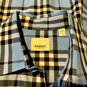Burberry London.  Never worn.  Dry cleaned once.
